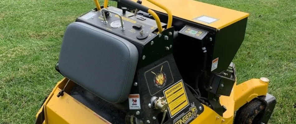 Yellow aerator machine on a lawn in Charlotte, NC.