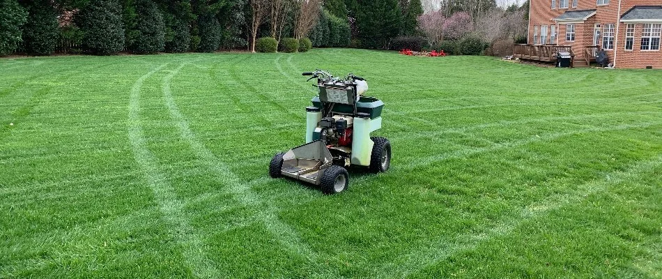 Granular spreader on a green lawn in Indian Land, SC.
