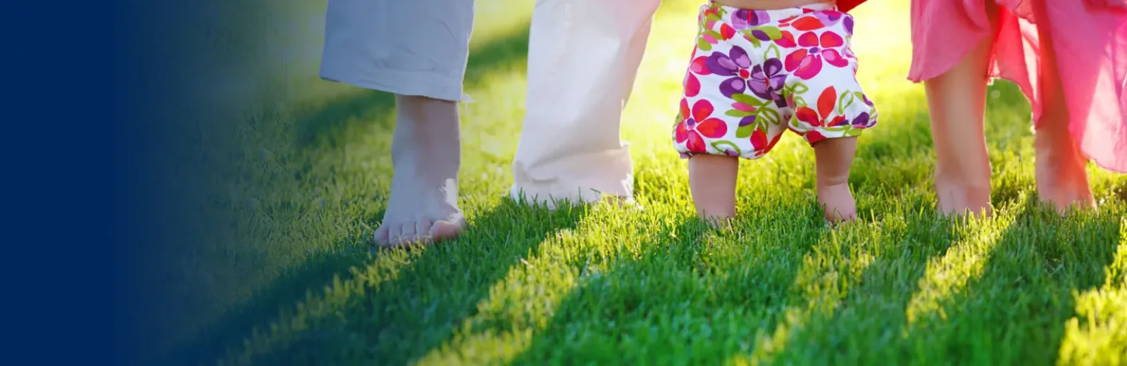 Family standing in green grass